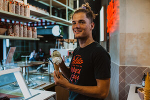 Island Gelato serving gelato scoop with a smile